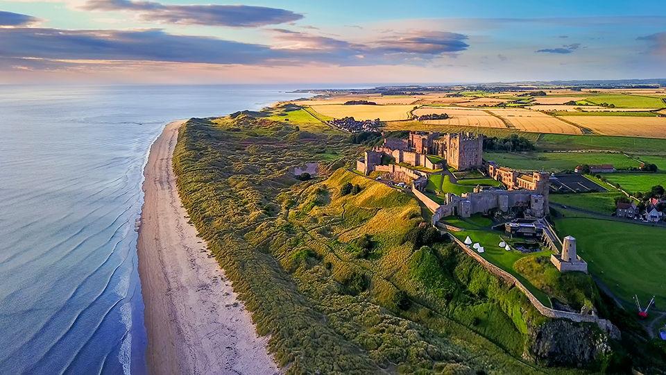 Aerial view of Bamburgh Castle on the coast of Northumberland, England.